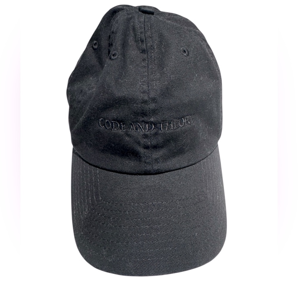 Black on black blind embossed baseball hat branded Code and Theory. GUC
